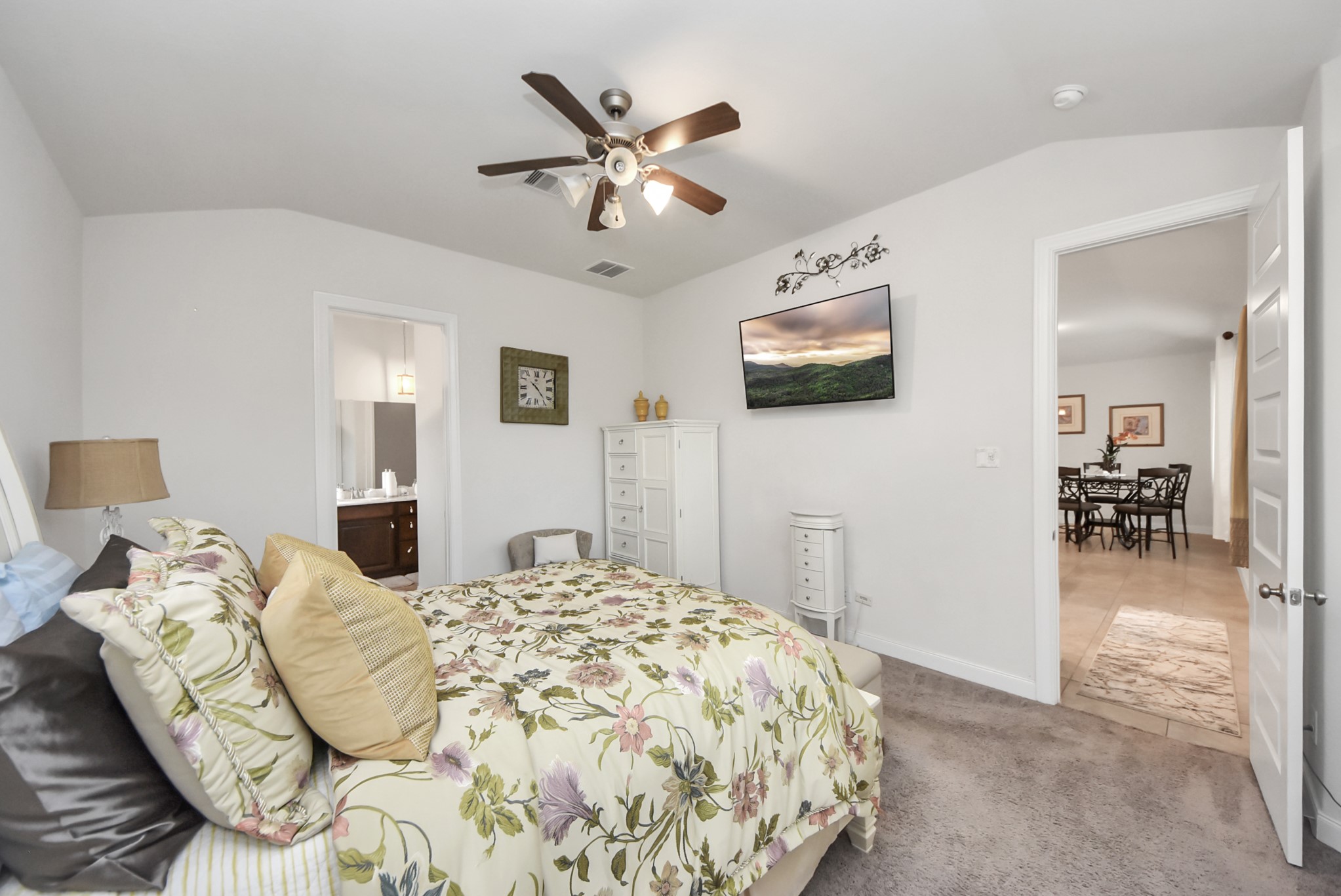 8806 Chapada Highlands Drive Cypress, TX 77433 - Photo 25 of 42 a bedroom with a large bed and a chandelier