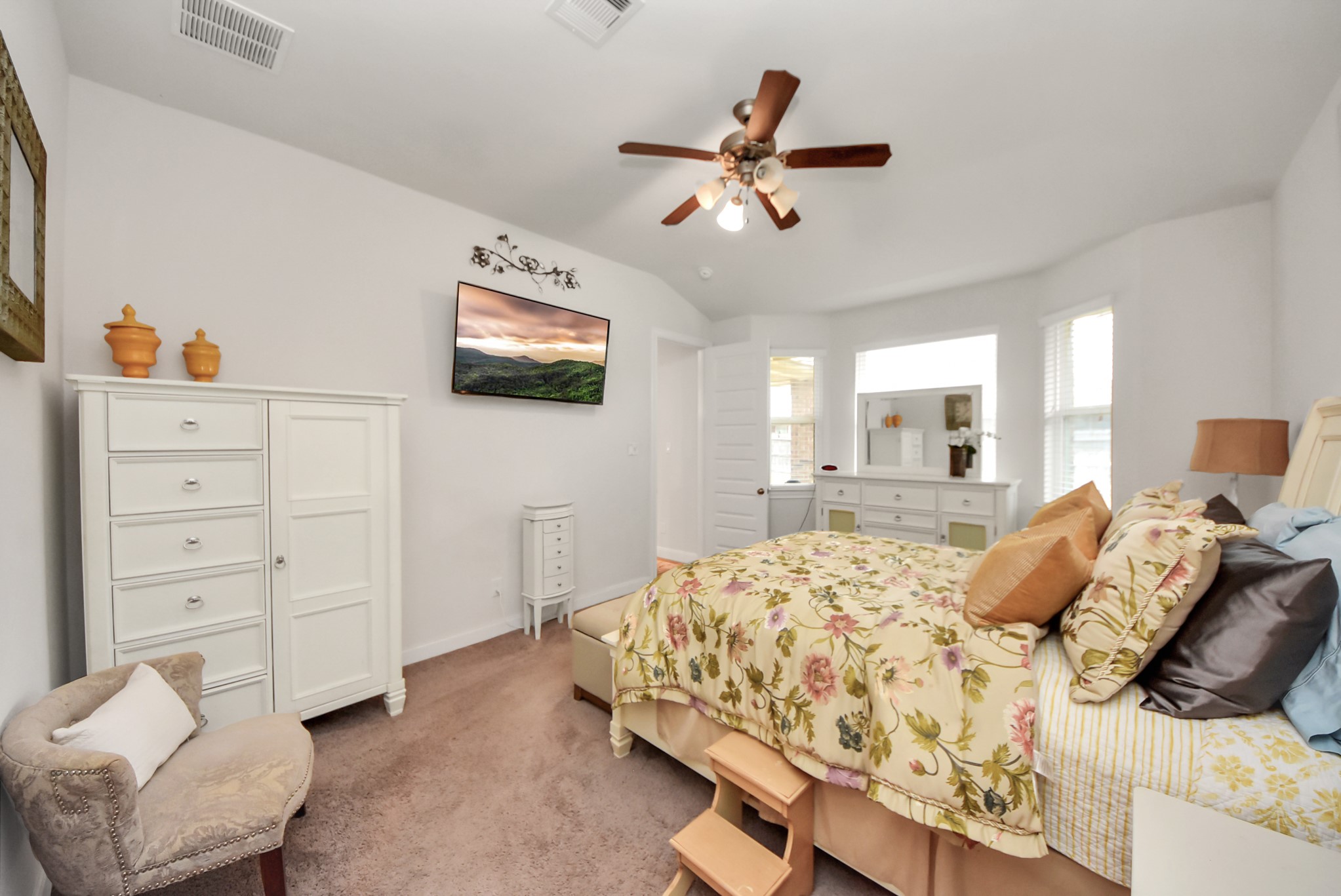 8806 Chapada Highlands Drive Cypress, TX 77433 - Photo 26 of 42 a bedroom with a large bed and a flat screen tv