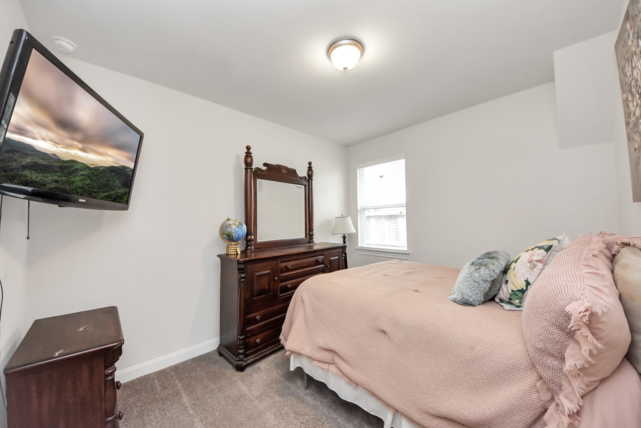 8806 Chapada Highlands Drive Cypress, TX 77433 - Photo 31 of 42 a bedroom with a bed and flat screen tv