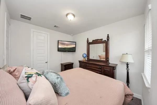 a bedroom with a bed and a flat screen tv