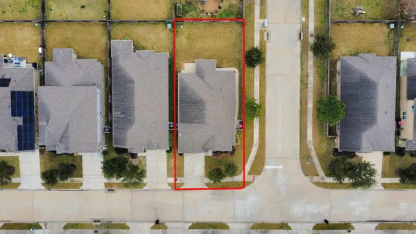 an aerial view of a residential houses with outdoor space