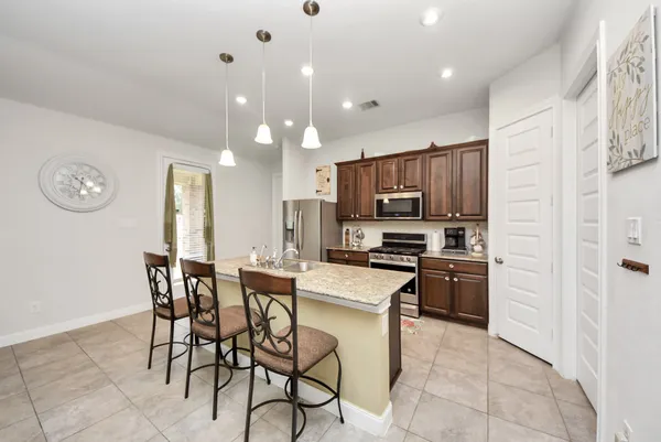 a kitchen with stainless steel appliances a refrigerator stove microwave and cabinets