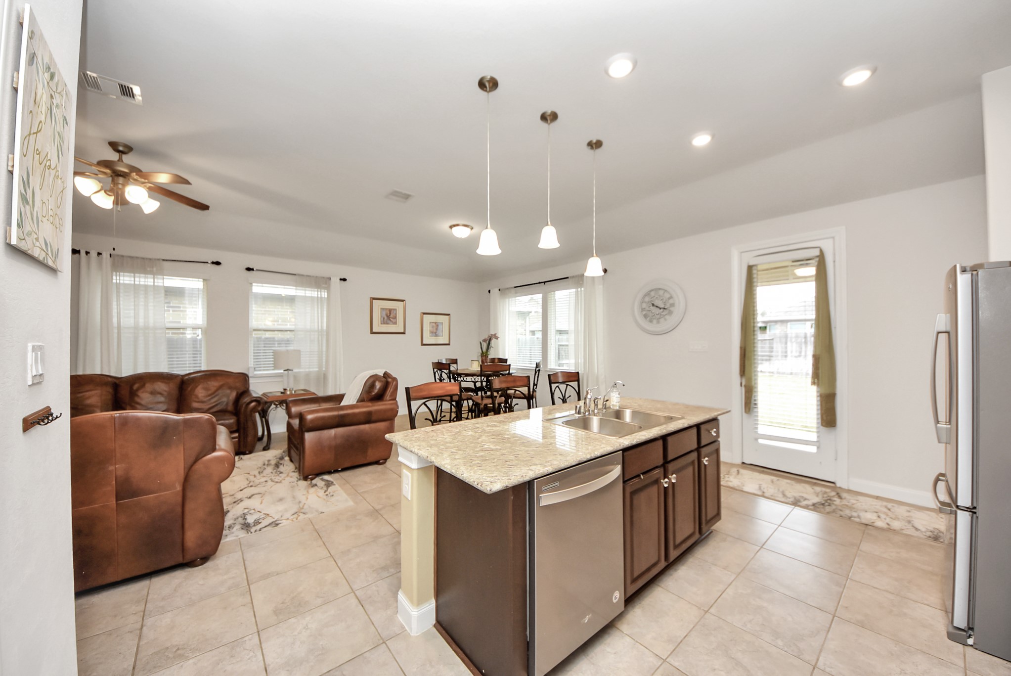8806 Chapada Highlands Drive Cypress, TX 77433 - Photo 8 of 42 a large white kitchen with a large island in the center