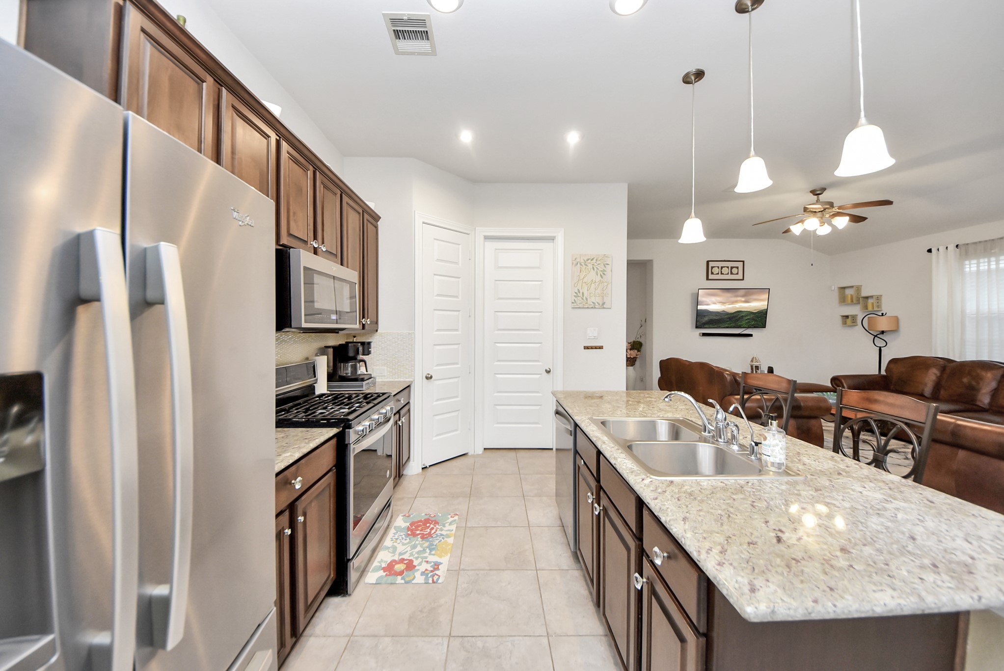 8806 Chapada Highlands Drive Cypress, TX 77433 - Photo 10 of 42 a kitchen with stainless steel appliances granite countertop a sink a stove and a refrigerator