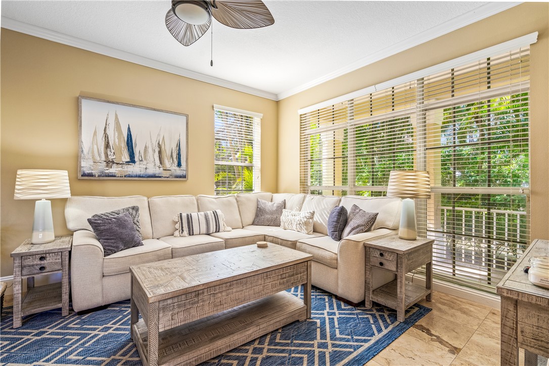 8705 Palm Tree Lane Vero Beach, FL 32963 - Photo 1 of 31 a living room with furniture and a large window
