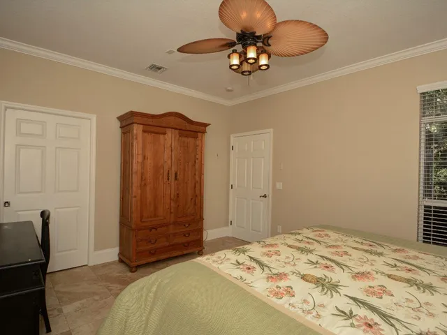 a bedroom with a bed and cabinets