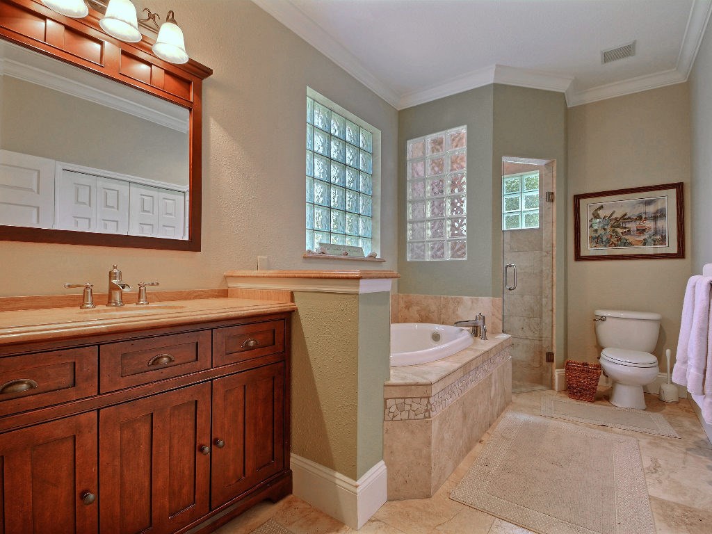 8705 Palm Tree Lane Vero Beach, FL 32963 - Photo 13 of 31 a spacious bathroom with a tub sink and mirror