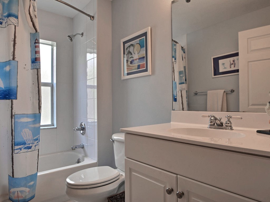 8705 Palm Tree Lane Vero Beach, FL 32963 - Photo 14 of 31 a bathroom with a sink a toilet and shower