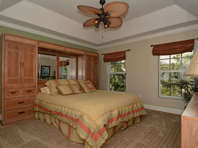 a bedroom with a large bed and a chandelier