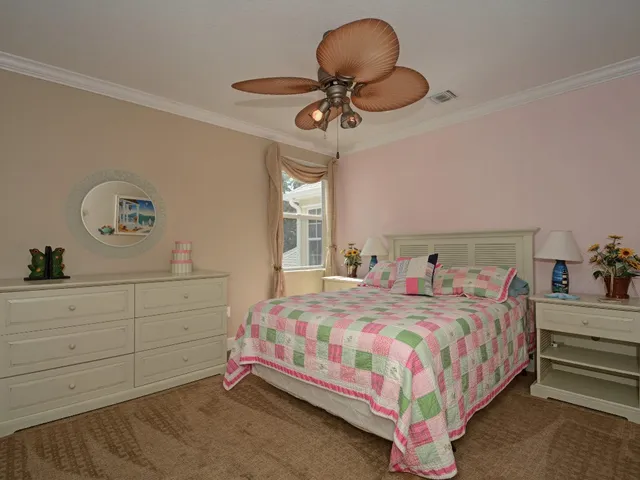 a bedroom with a bed and chandelier