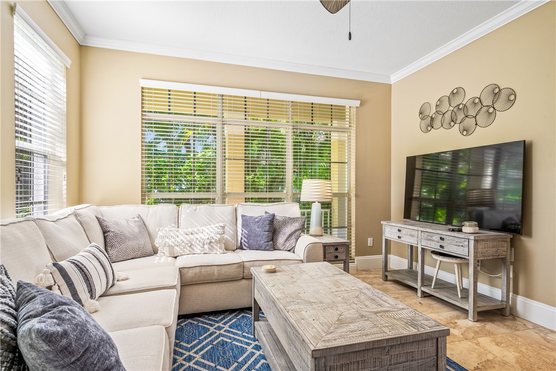 8705 Palm Tree Lane Vero Beach, FL 32963 - Photo 2 of 31 a living room with furniture and a flat screen tv