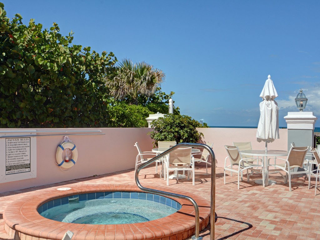 8705 Palm Tree Lane Vero Beach, FL 32963 - Photo 30 of 31 a view of a chairs and table in the backyard