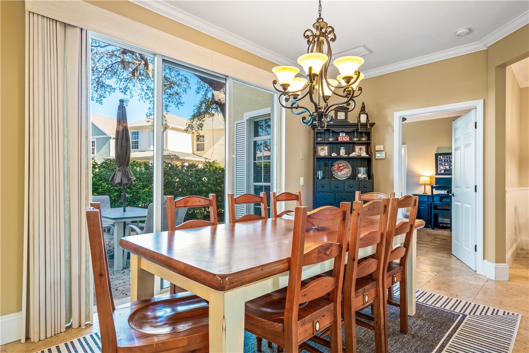 8705 Palm Tree Lane Vero Beach, FL 32963 - Photo 4 of 31 a view of a dining room with furniture wooden floor and chandelier