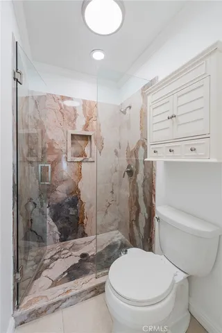 a bathroom with a toilet and a shower