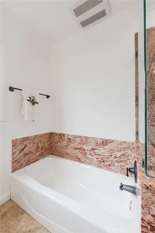 a bathroom with a bathtub and shower