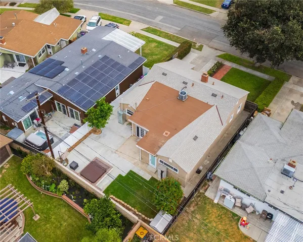 an aerial view of a house with a garden and trees