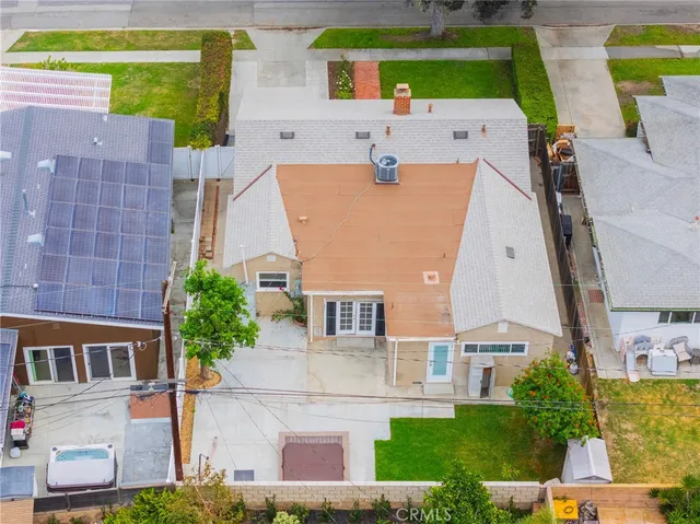 an aerial view of residential houses with outdoor space and parking