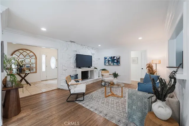 a living room with furniture a flat screen tv and a rug