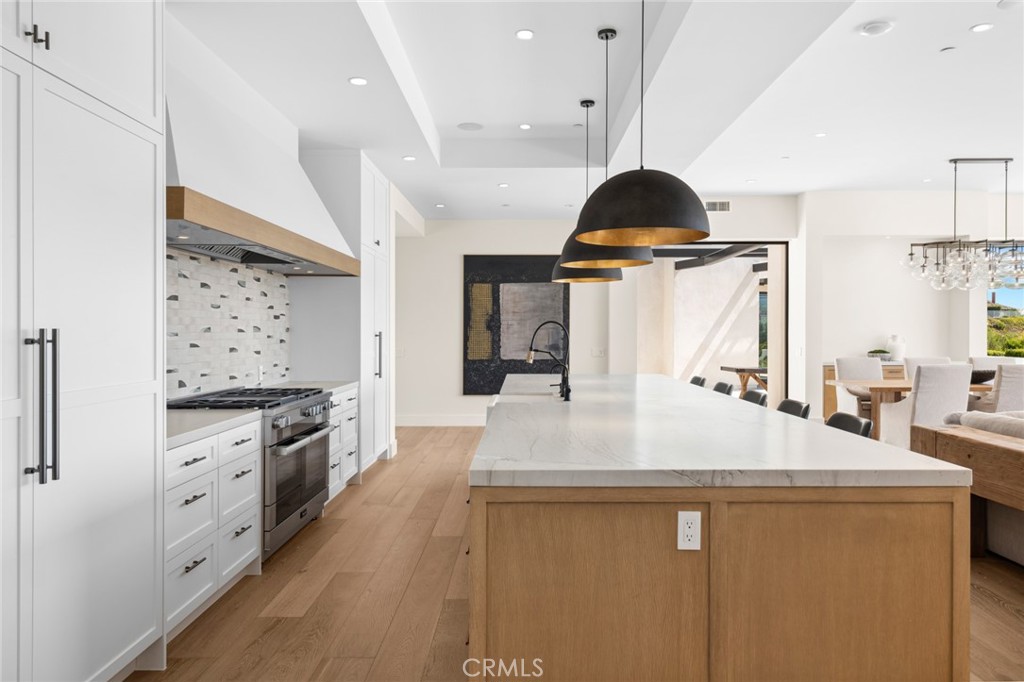 2 Twin Lakes Circle Corona del Mar, CA 92625 - Photo 12 of 31 a kitchen with stainless steel appliances a stove refrigerator and wooden floor