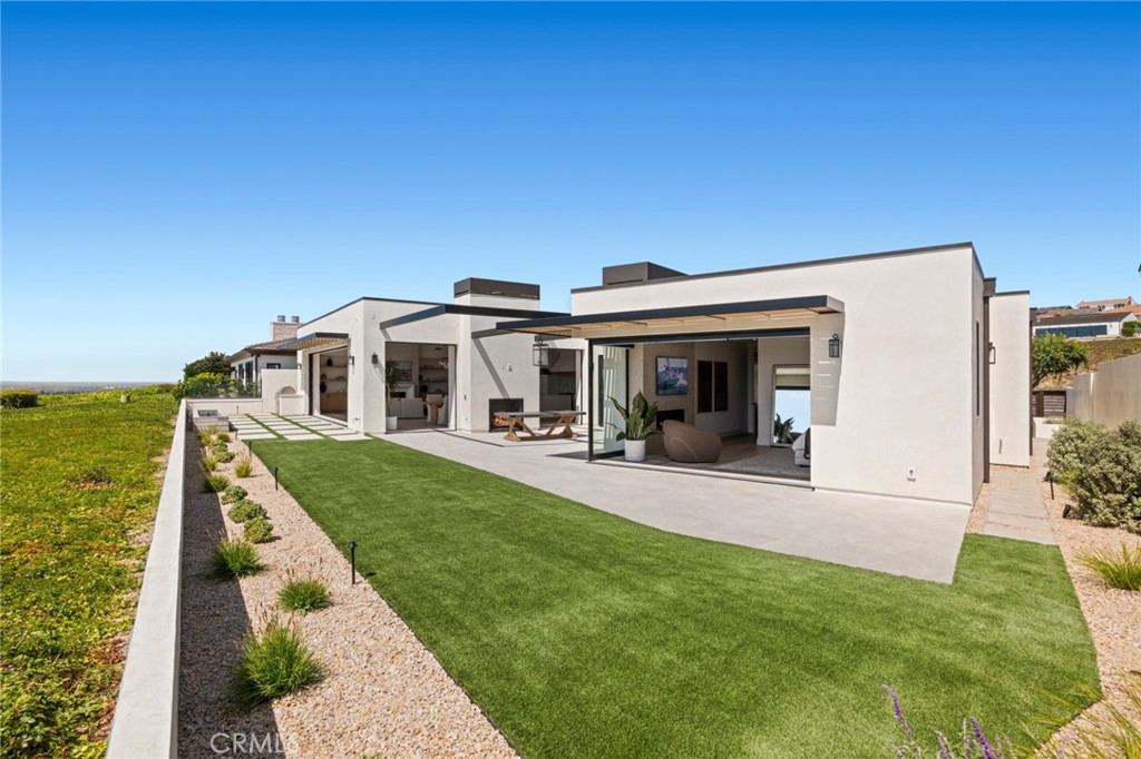 2 Twin Lakes Circle Corona del Mar, CA 92625 - Photo 30 of 31 a front view of a house with swimming pool having outdoor seating