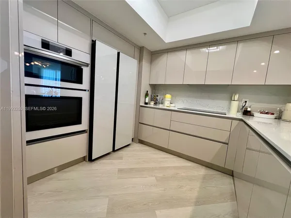 a kitchen with stainless steel appliances a refrigerator sink and cabinets