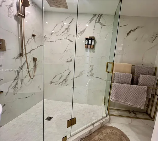 a bathroom with a white toilet tub and shower