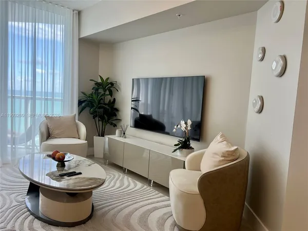 a living room with furniture and a potted plant