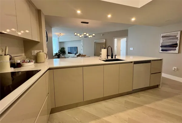 a kitchen with sink and view living room