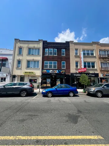 a view of a cars park in front of a building