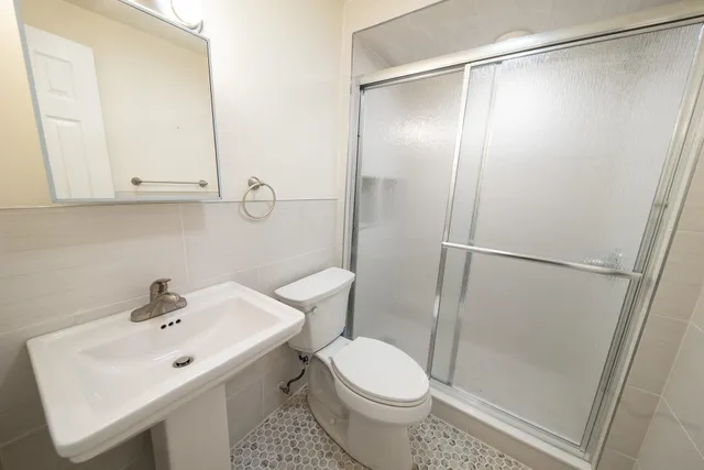 a bathroom with a sink toilet and shower