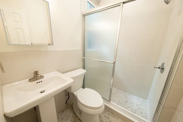 a bathroom with a sink toilet and shower