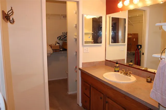 a en suite bathroom with a sink and mirror