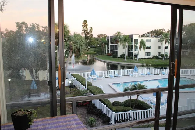 an aerial view of a house with a swimming pool yard and outdoor seating