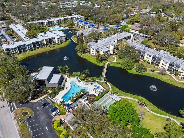 an aerial view of a house with a swimming pool patio and outdoor seating