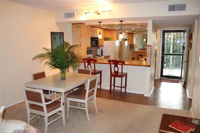a dining room with furniture and wooden floor