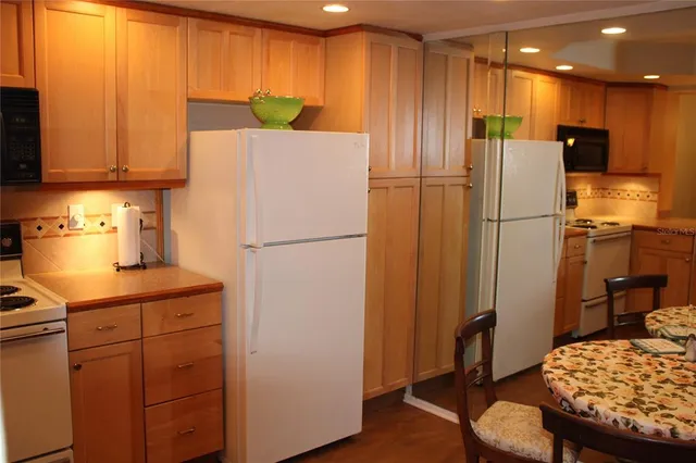 a kitchen with a refrigerator a stove and a microwave