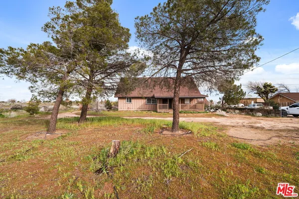 a view of a house with swimming pool and sitting area