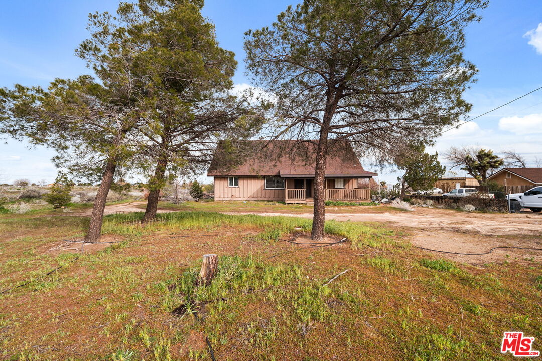 a view of a house with swimming pool and sitting area
