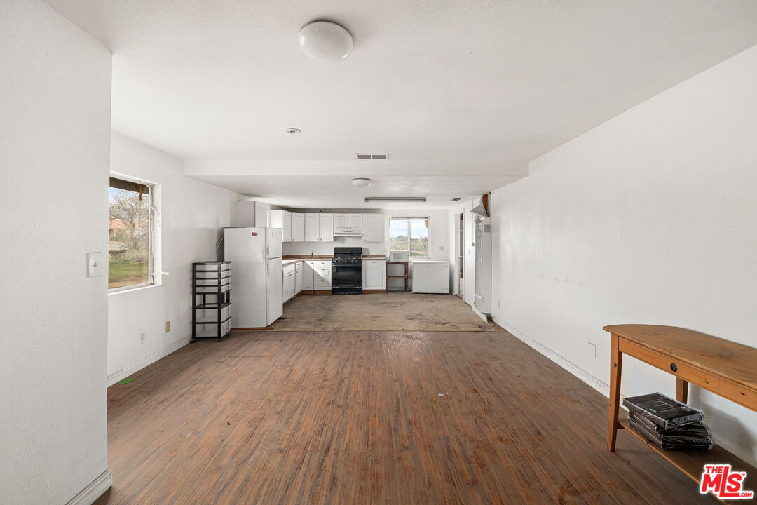 6906 Phelan Road Phelan, CA 92371 - Photo 7 of 42 a view of a kitchen with furniture and an empty room
