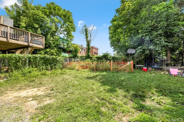 a backyard of a house with lots of green space and plants
