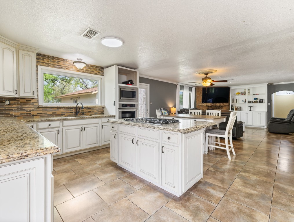 496 James Street Clute, TX 77531 - Photo 11 of 45 a kitchen with appliances cabinets and a counter top space