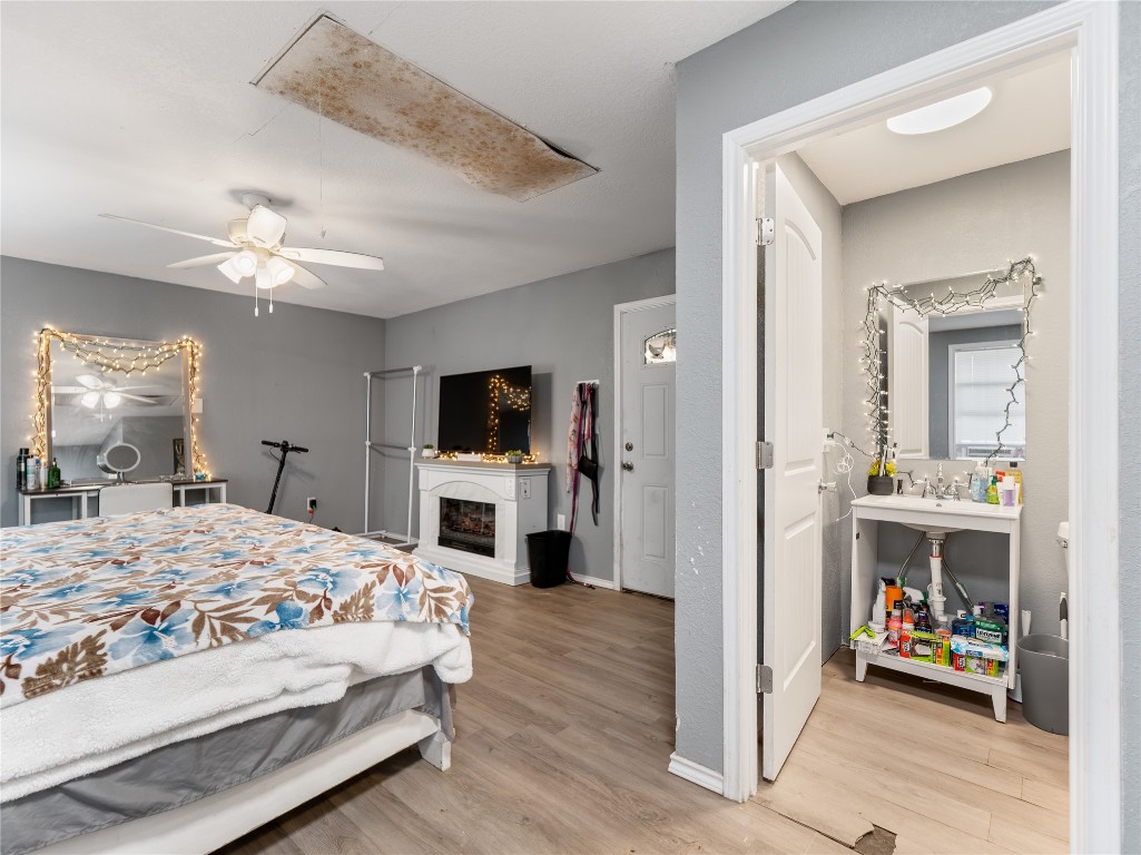 496 James Street Clute, TX 77531 - Photo 16 of 45 a bedroom with a bed a flat screen tv and a chandelier