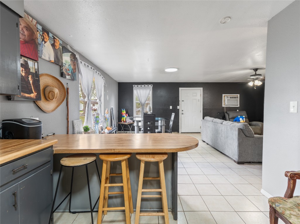 496 James Street Clute, TX 77531 - Photo 20 of 45 a dining hall with stainless steel appliances kitchen island granite countertop a table chairs and a refrigerator