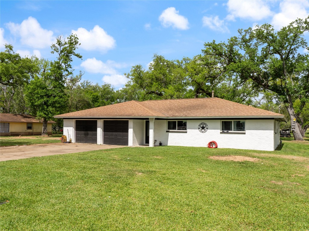496 James Street Clute, TX 77531 - Photo 2 of 45 a view of a house with a yard and large tree