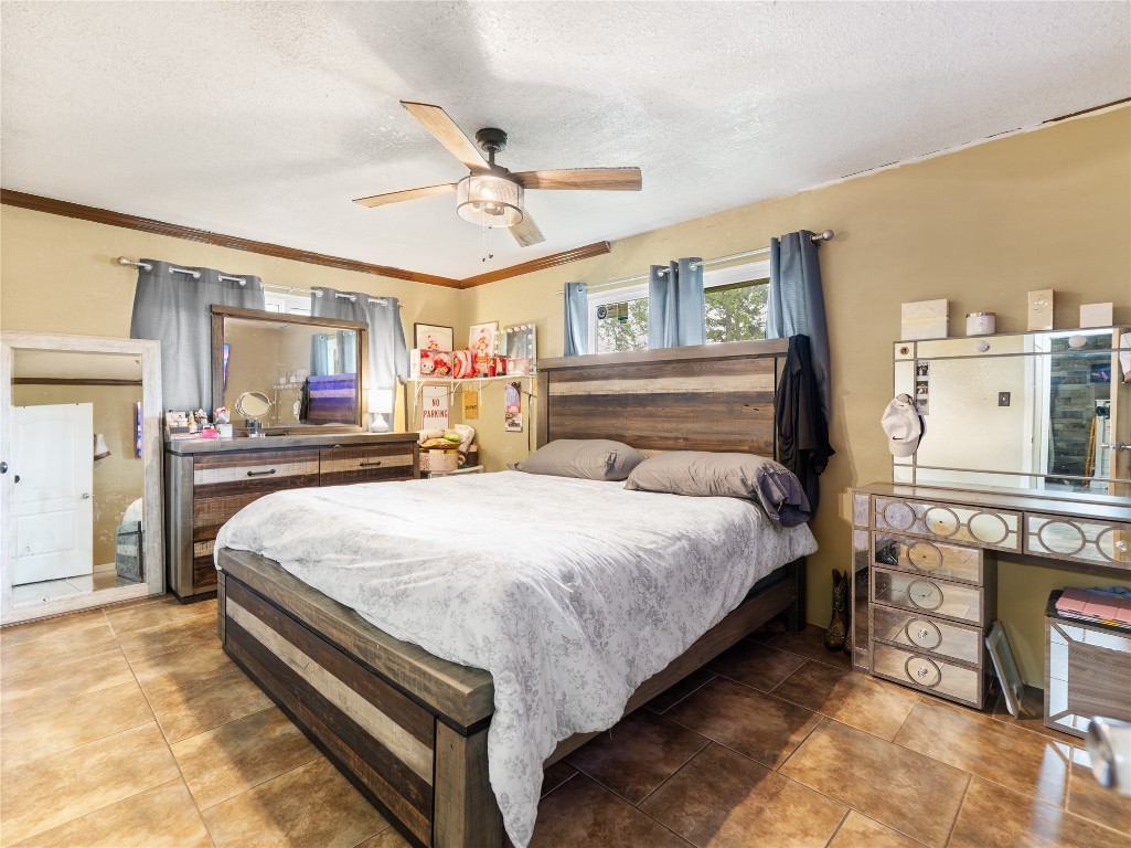 496 James Street Clute, TX 77531 - Photo 32 of 45 a bedroom with a bed and dresser with mirror