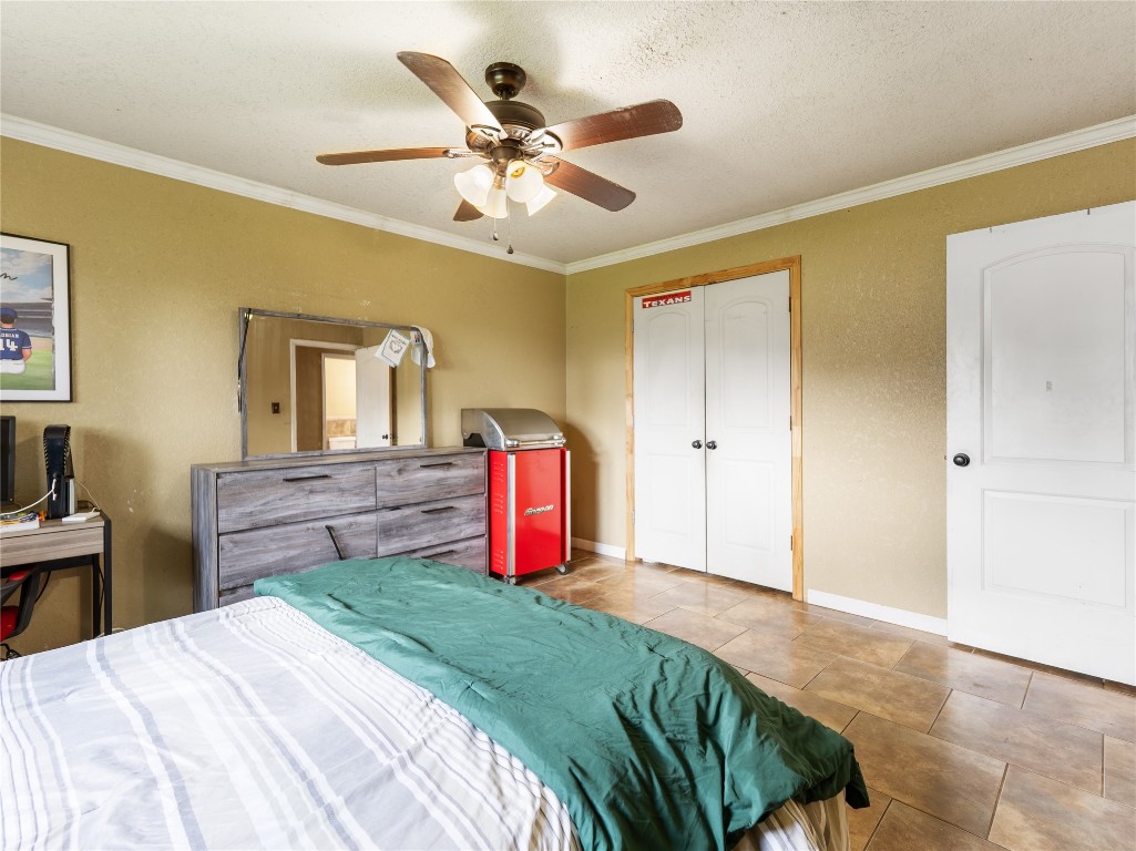 496 James Street Clute, TX 77531 - Photo 33 of 45 a bedroom with a bed and a chandelier