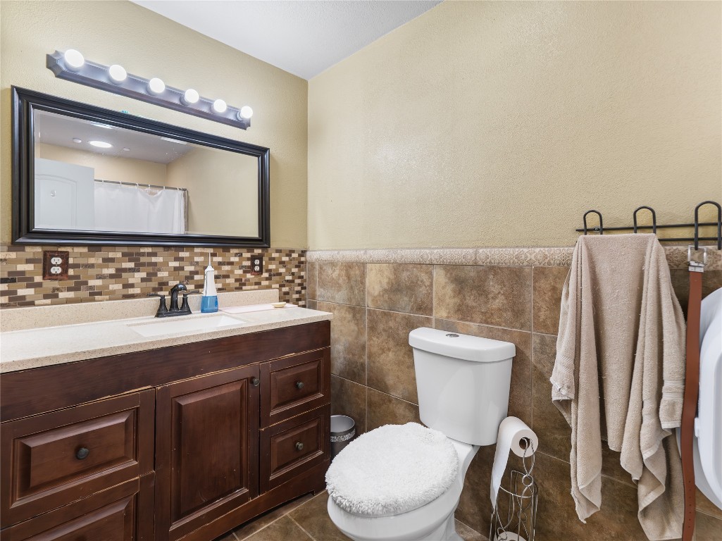 496 James Street Clute, TX 77531 - Photo 35 of 45 a bathroom with a toilet sink and mirror