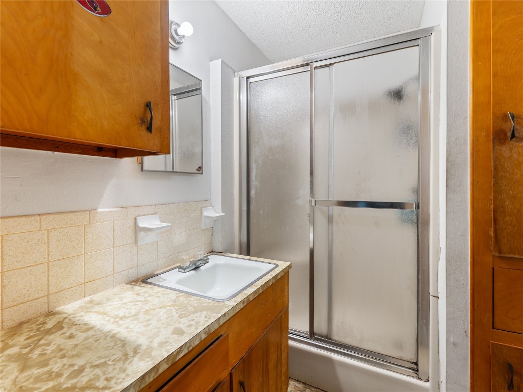 496 James Street Clute, TX 77531 - Photo 37 of 45 a bathroom with a granite countertop sink and a mirror