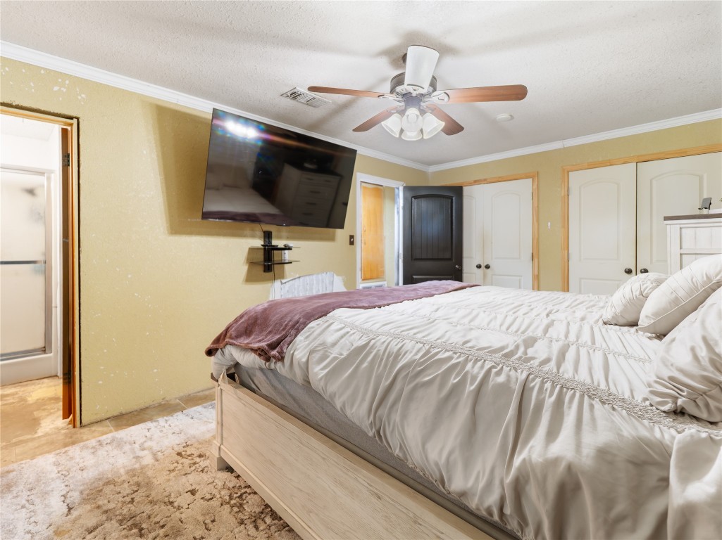 496 James Street Clute, TX 77531 - Photo 38 of 45 a bed room with a bed mirror and a flat tv screen on dresser