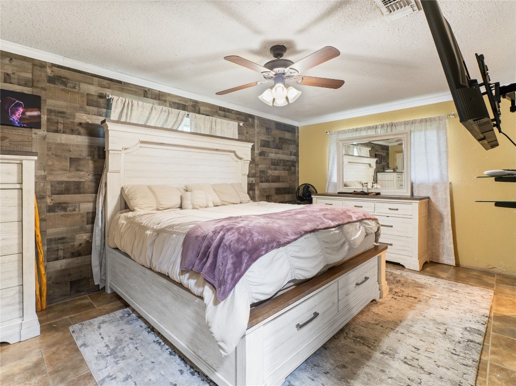 496 James Street Clute, TX 77531 - Photo 40 of 45 a spacious bedroom with a bed and a chandelier